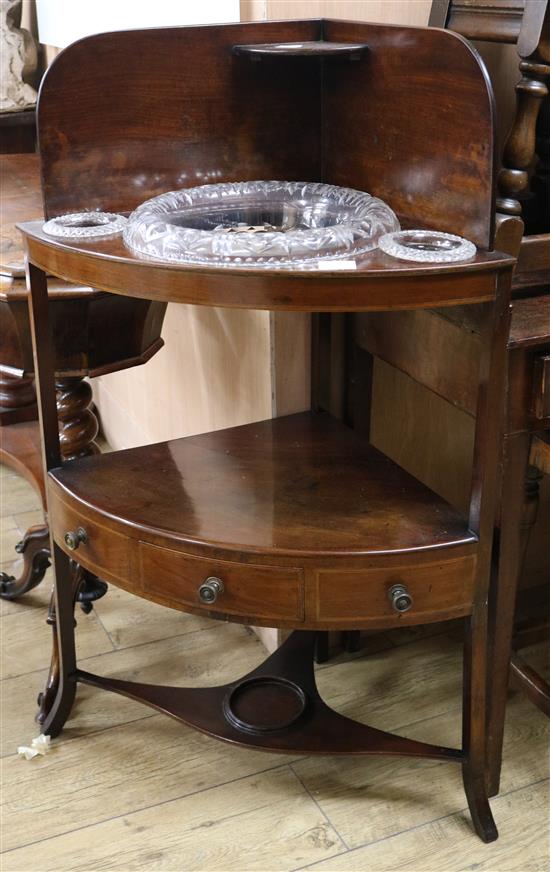 A George III mahogany two tier bowfronted wash stand, fitted with later cut glass bowls W.70cm